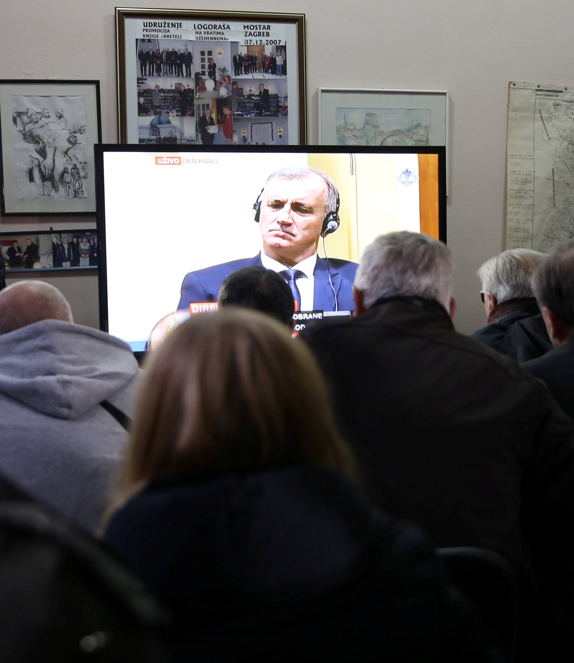 Union of former detainees watch a television broadcast of the appeal trial in the Hague, Netherlands, for six Bosnian Croat senior wartime officials accused of war crimes against Muslims in Bosnia's 1992-1995 war, in Mostar