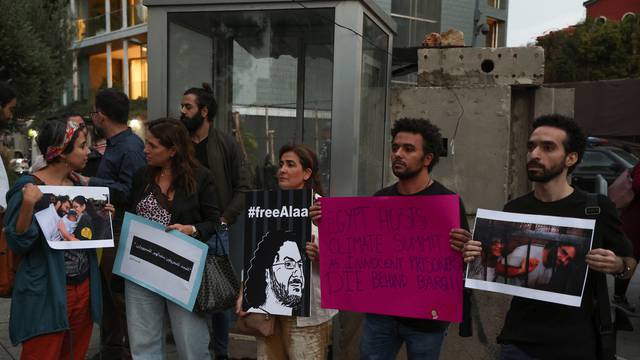 Demonstrators hold signs as they demand the release of Egyptian-British hunger striker Alaa Abd el-Fattah near the British Embassy in Beirut