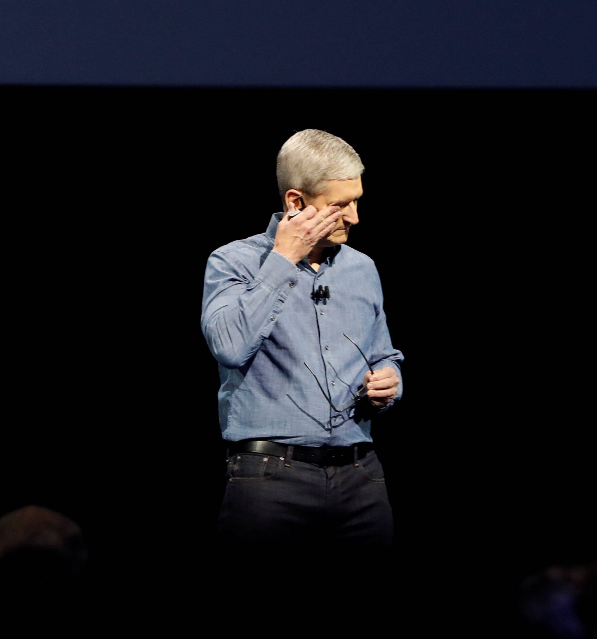 Apple Inc. CEO Tim Cook wipes his eyes after leading a moment of silence for the victims of the attack in Orlando as he opens the company's World Wide Developers Conference in San Francisco, California