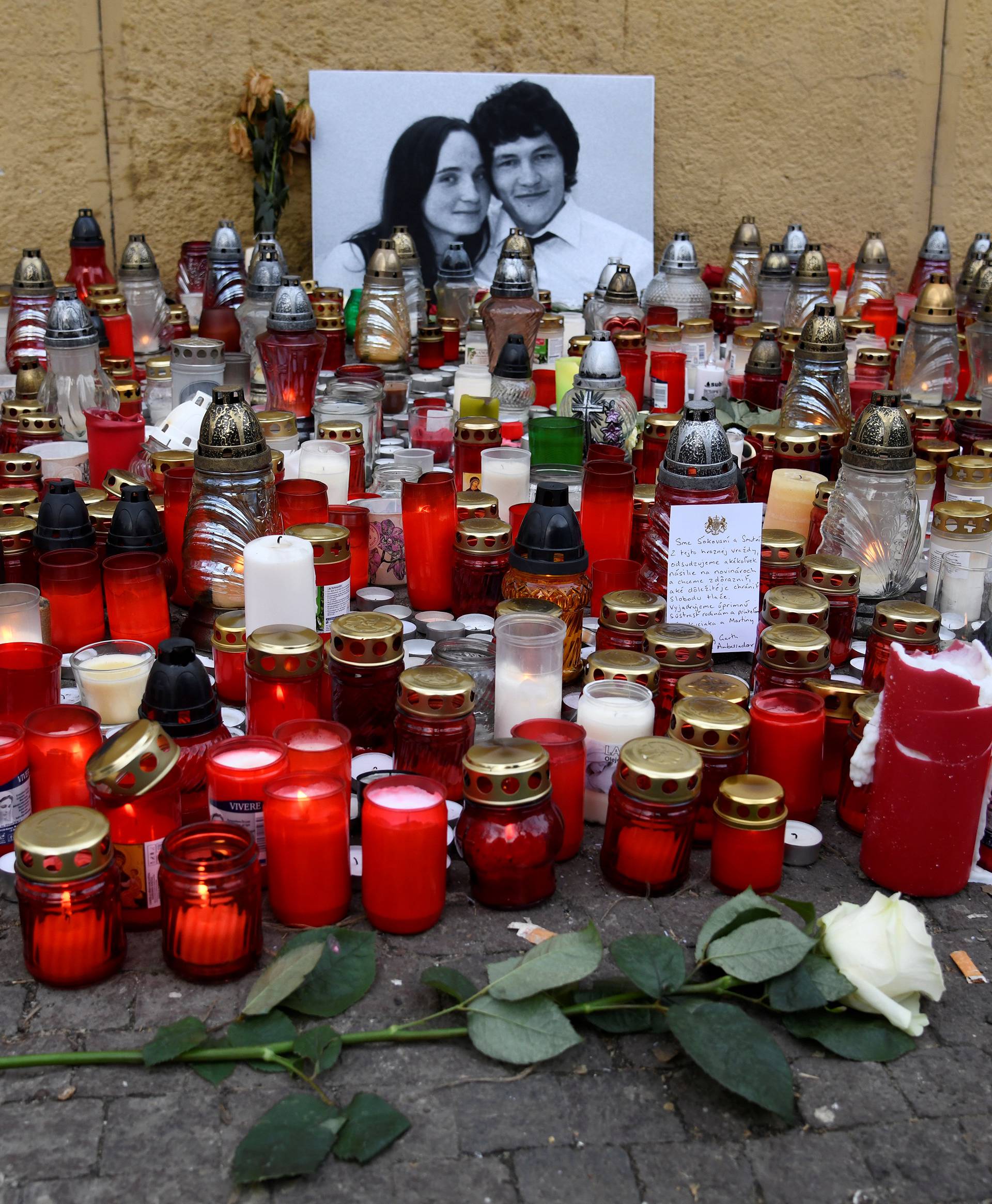 Candles and flowers are left for a tribute to murdered Slovak investigative reporter Jan Kuciak at Slovak National Uprising Square in Bratislava