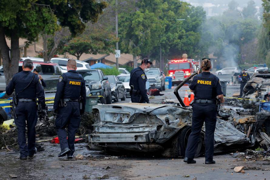 Crash scene after a civilian aircraft went down in a military neighborhood, in San Diego