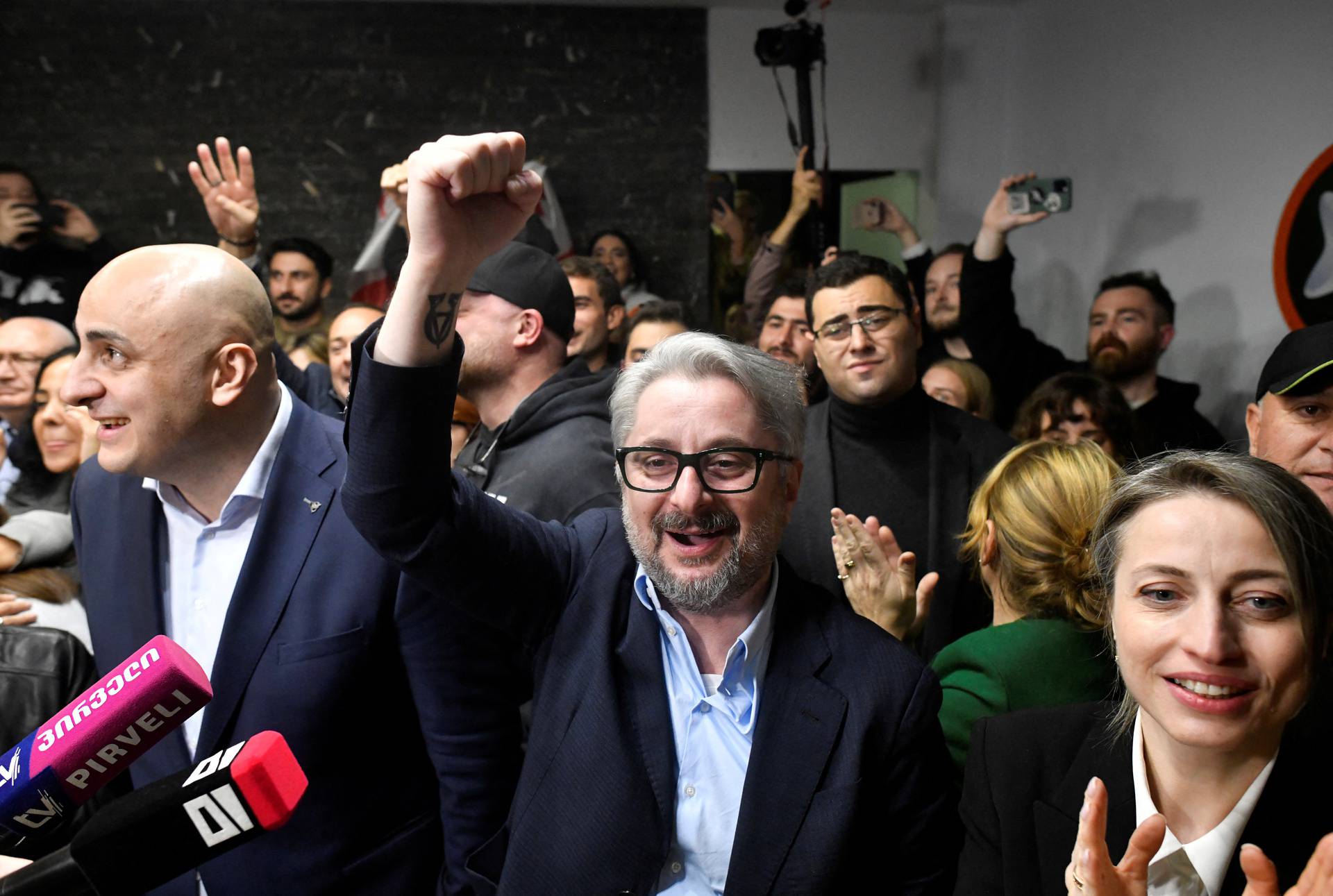 Leaders of the Coalition for Change react after the announcement of exit poll results in Tbilisi