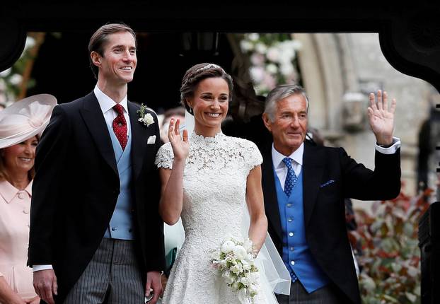 FILE PHOTO: Pippa Middleton and James Matthews pose for photographs after their wedding at St Mark