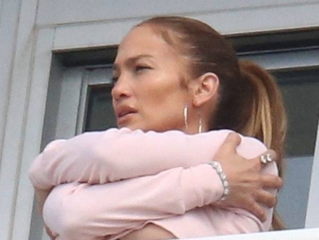EXCLUSIVE: Jennifer Lopez flashes some serious under-boob on her hotel balcony in Miami
