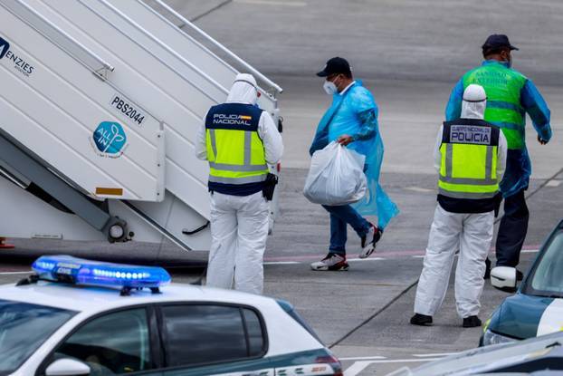 Passengers of the cruise ship MV Hondius, which was affected by a hantavirus outbreak, arrive at Tenerife Sud airport