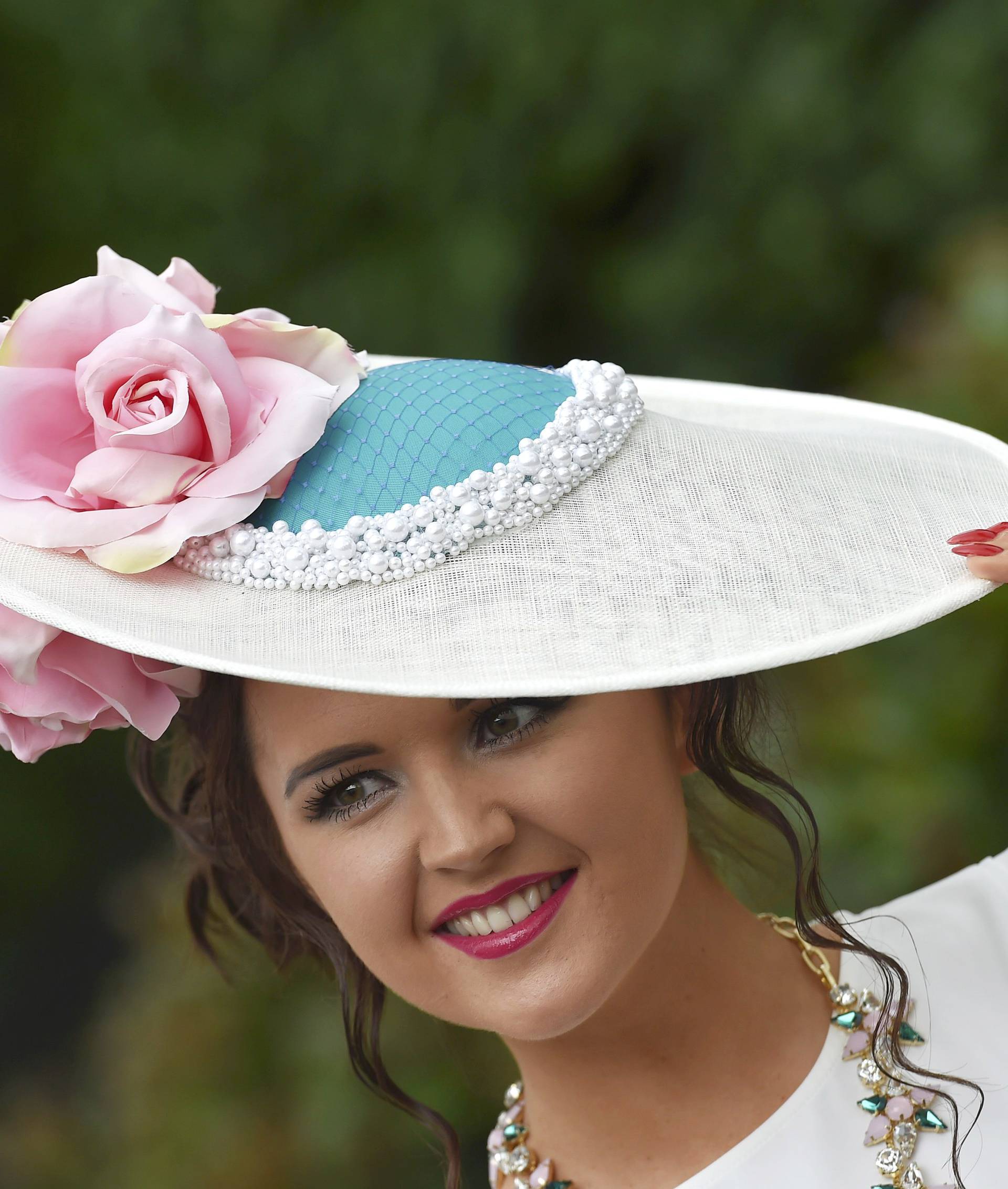 Britain Horse Racing Ladies Day Racegoer wears hat