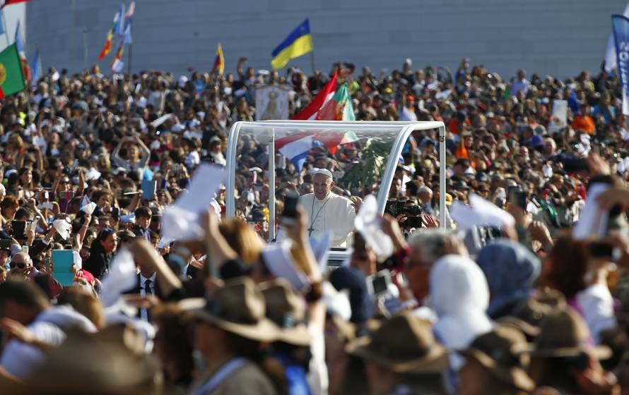 Pope Francis waves as he arrives at the Shrine of Our Lady of Fatima in Portugal