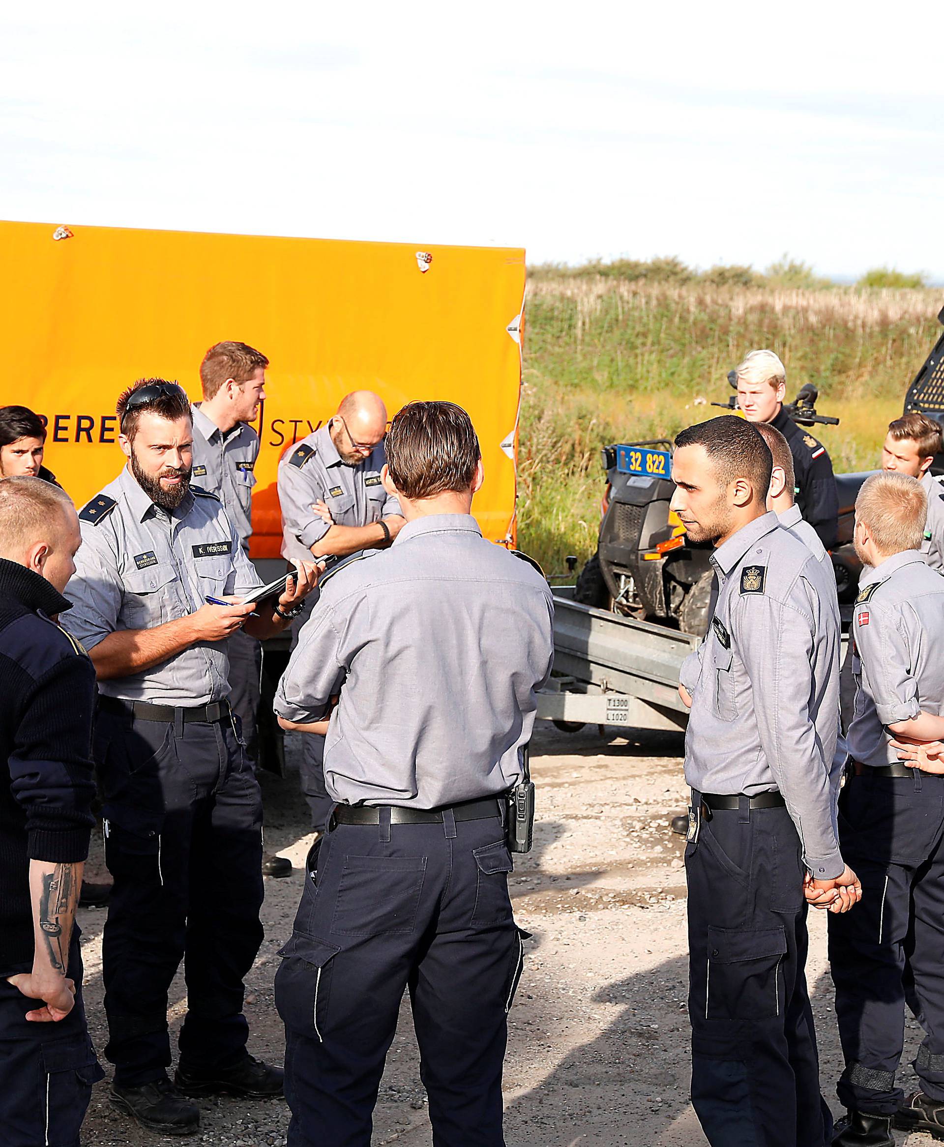 Members of The Danish Emergency Management Agency (DEMA) (Danish: Beredskabsstyrelsen) prepare to assist police at Kalvebod Faelled in Copenhagen