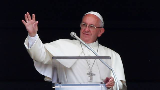 Pope Francis waves during his Sunday Angelus prayer in Saint Peter's square at the Vatican
