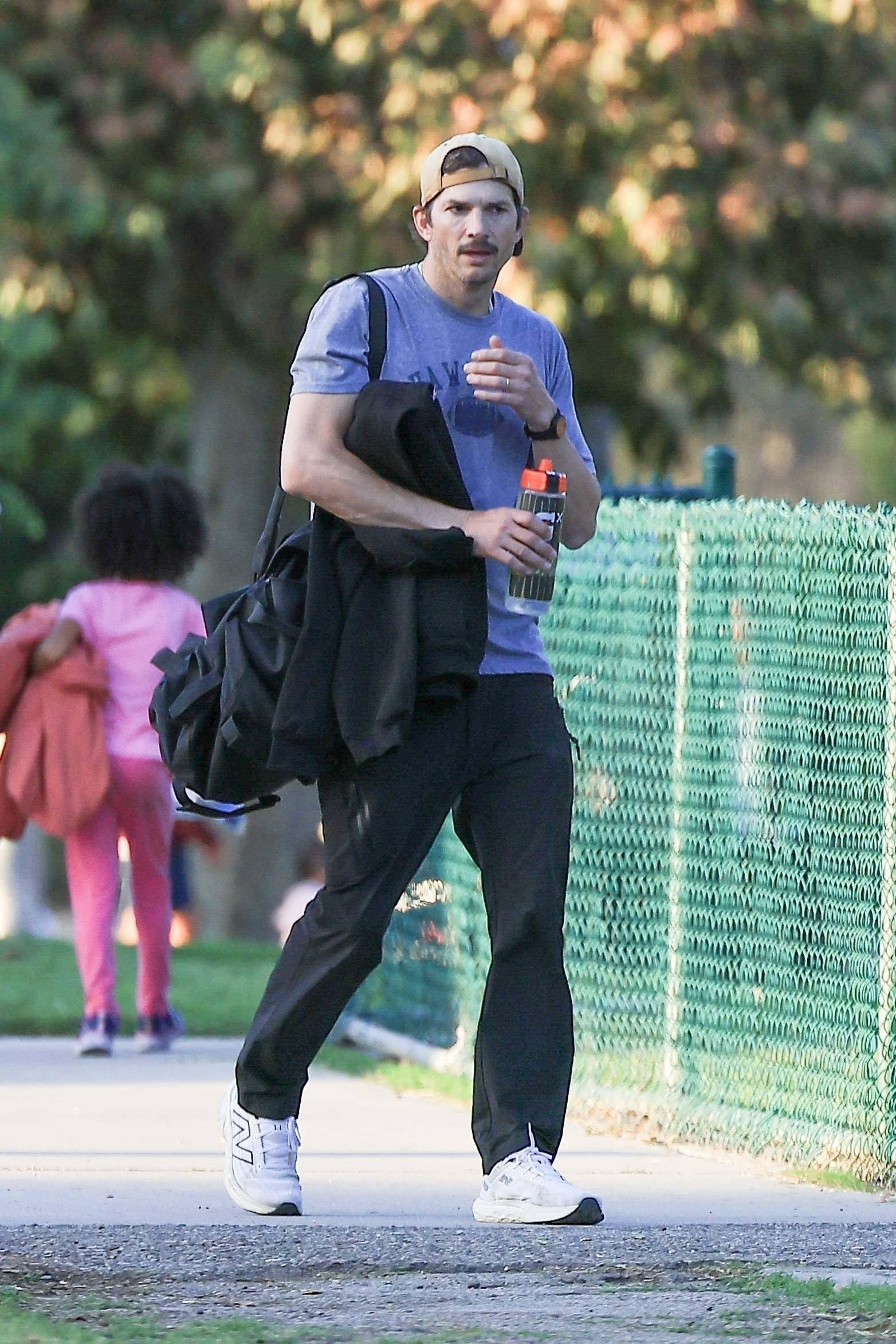 *EXCLUSIVE* Ashton Kutcher sports a mustache as he is seen taking his son to flag football, while Mila Kunis takes daughter to dance class in LA