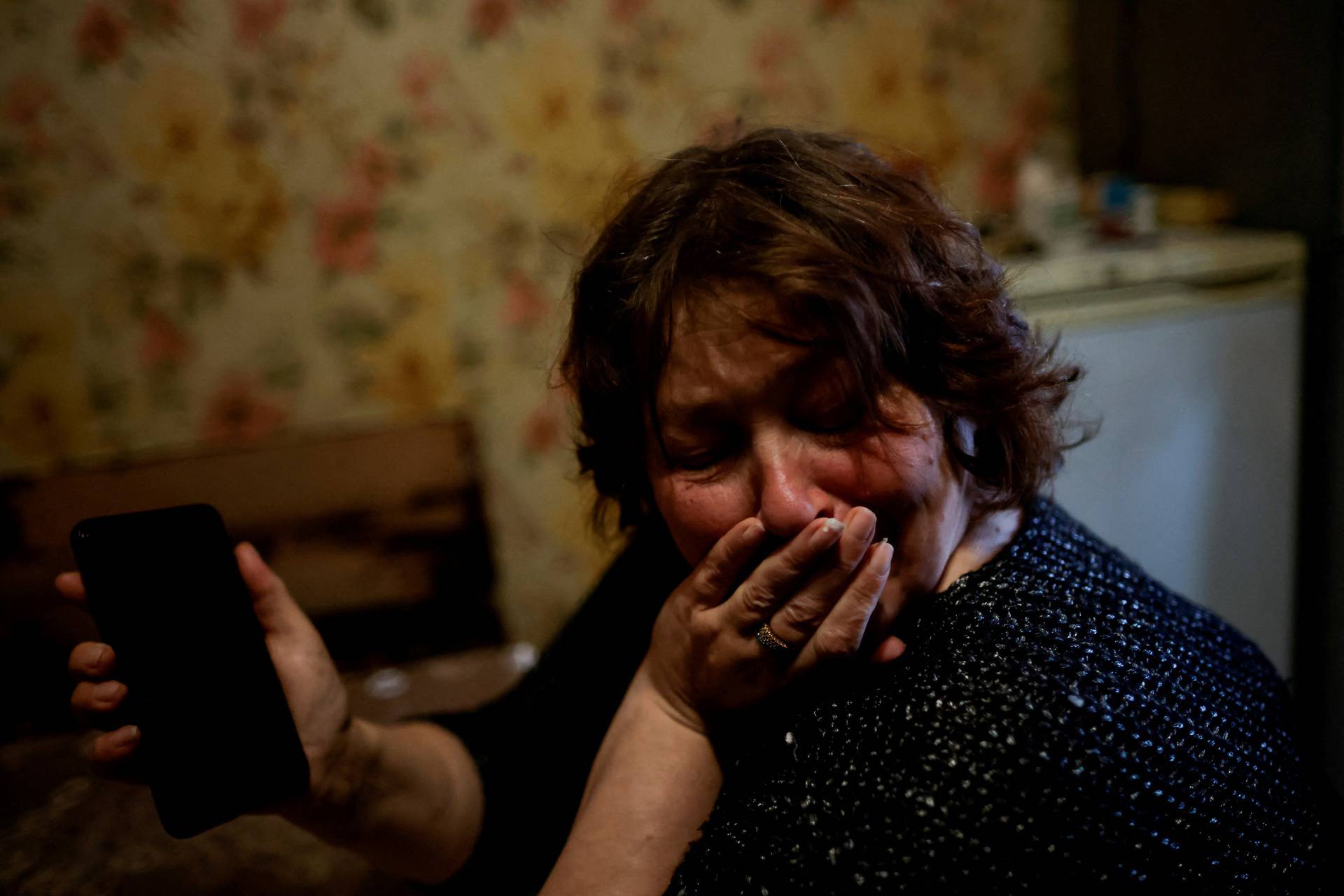 A Ukrainian woman Zhanna Lishchynska cries after talking on mobile phone with her husband, in Zaporizhzhya