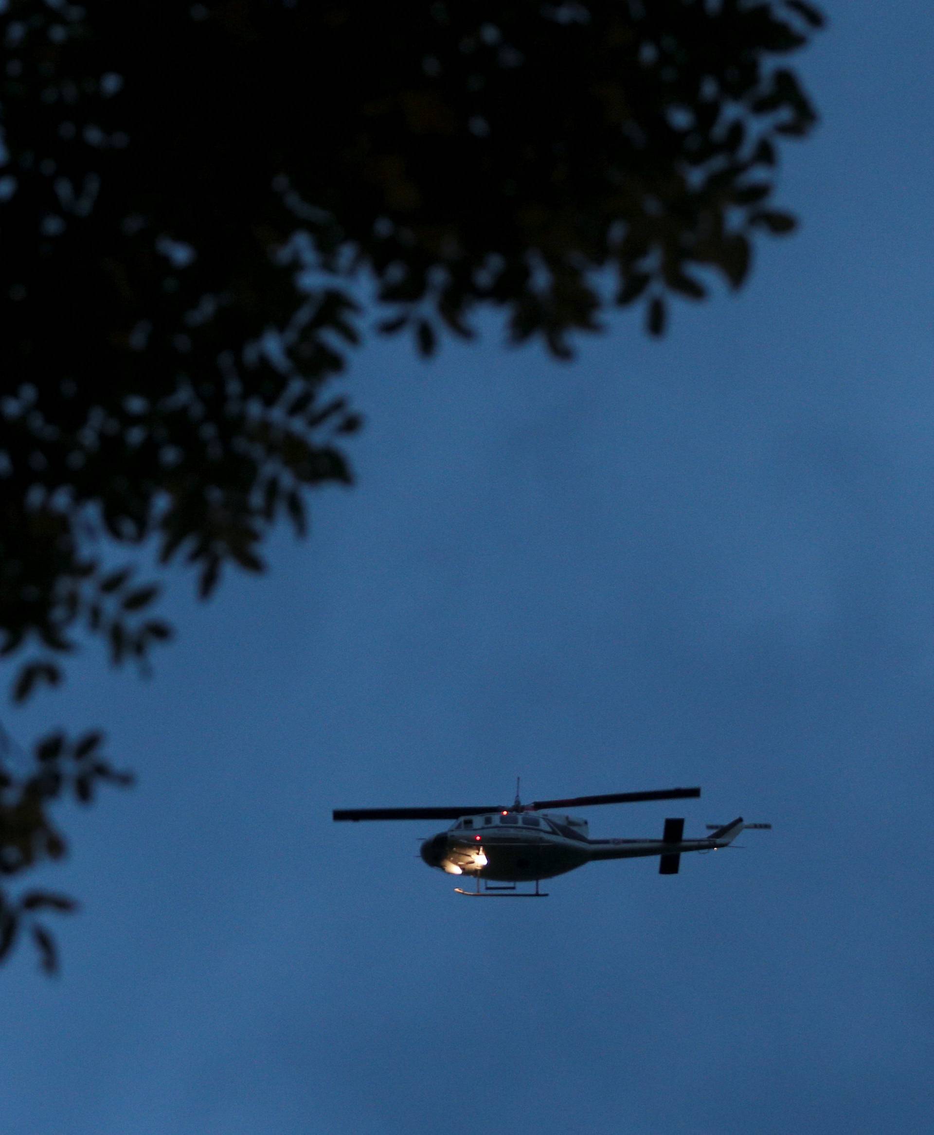 A police helicopter flies over the Tham Luang cave in the northern province of Chiang Rai