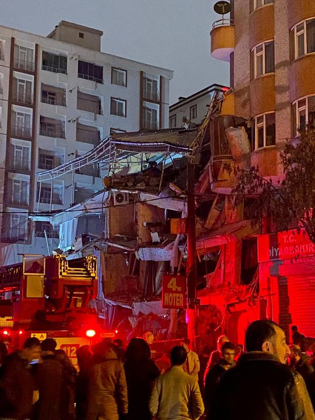 Emergency crew attends to a partially collapsed building following an earthquake in Diyarbakir