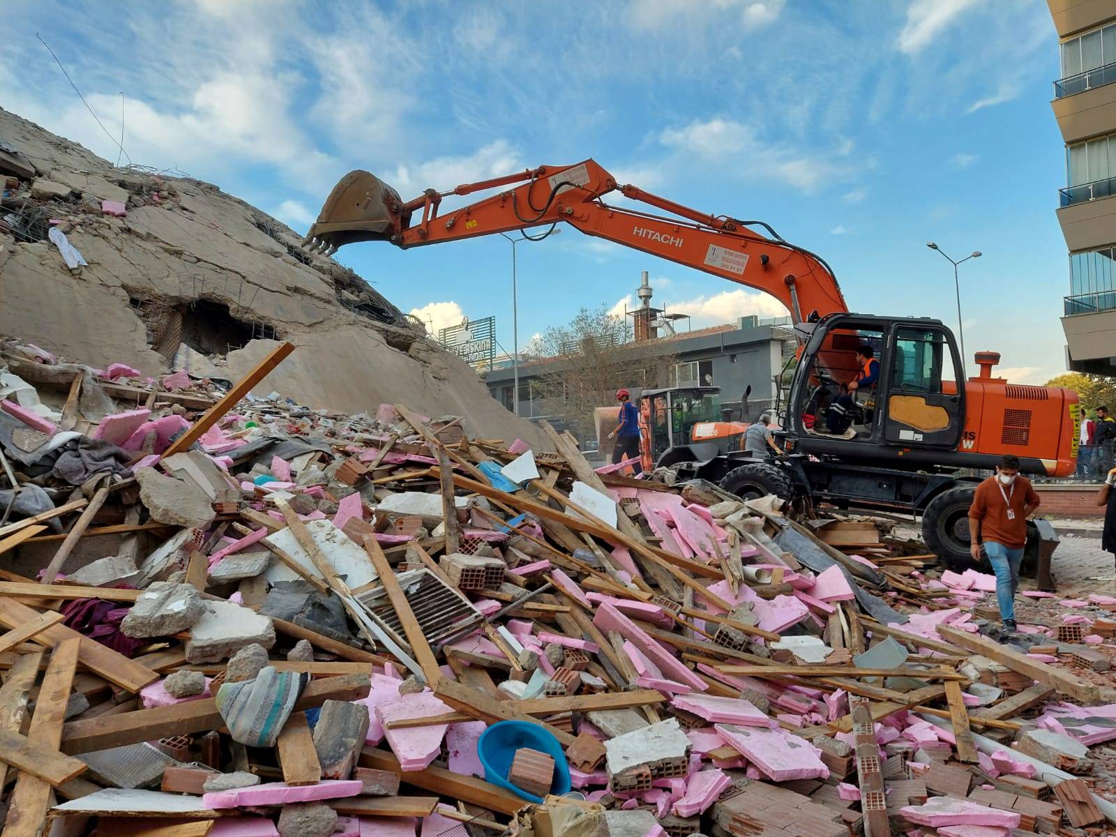 People search for survivors at a collapsed building after a strong earthquake struck the Aegean Sea where some buildings collapsed in the coastal province of Izmir