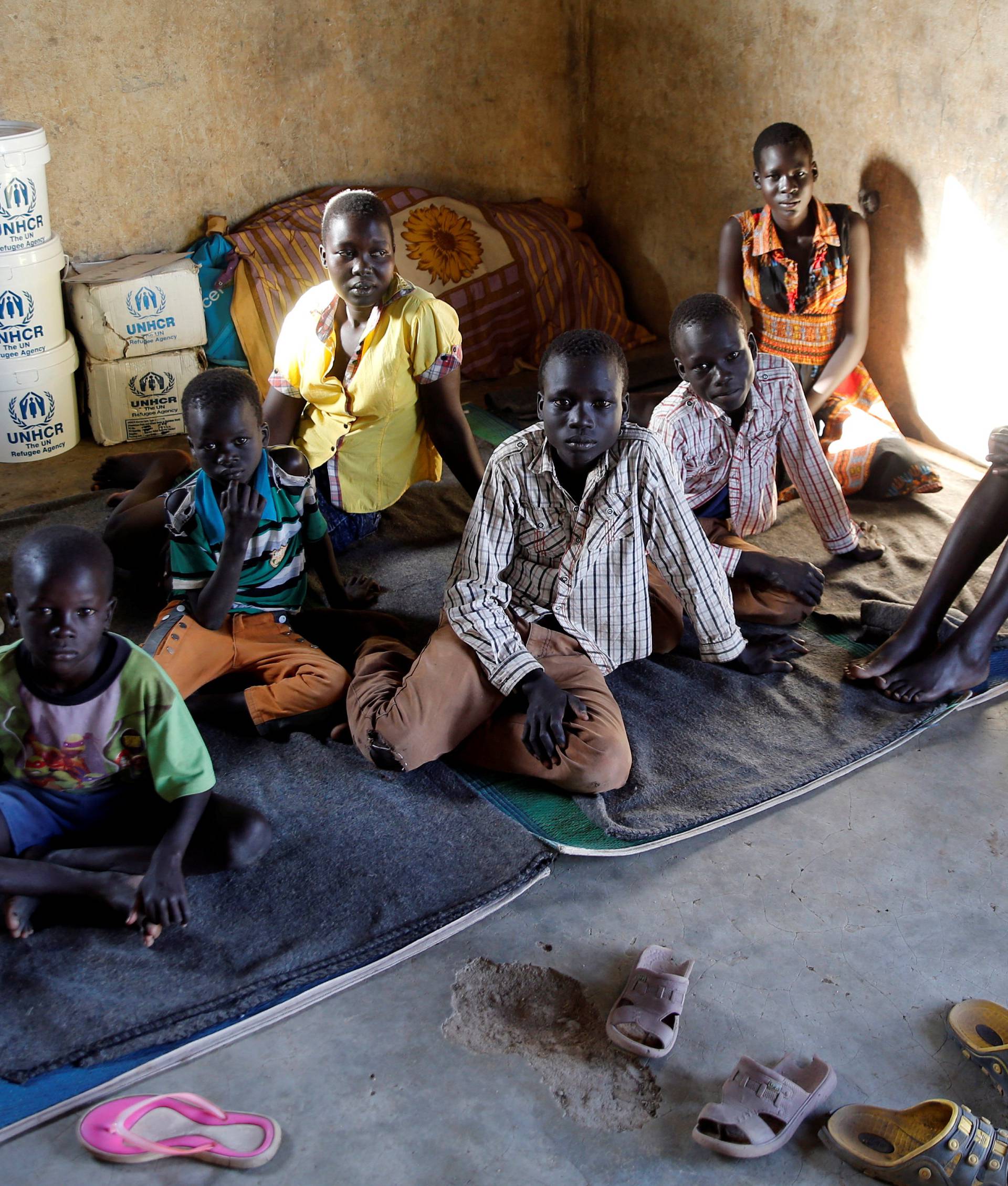 A South Sudanese refugee family from Jonglei State sits inside a makeshift structure at the reception centre of the Kakuma refugee camp in Turkana county, northwest of Nairobi