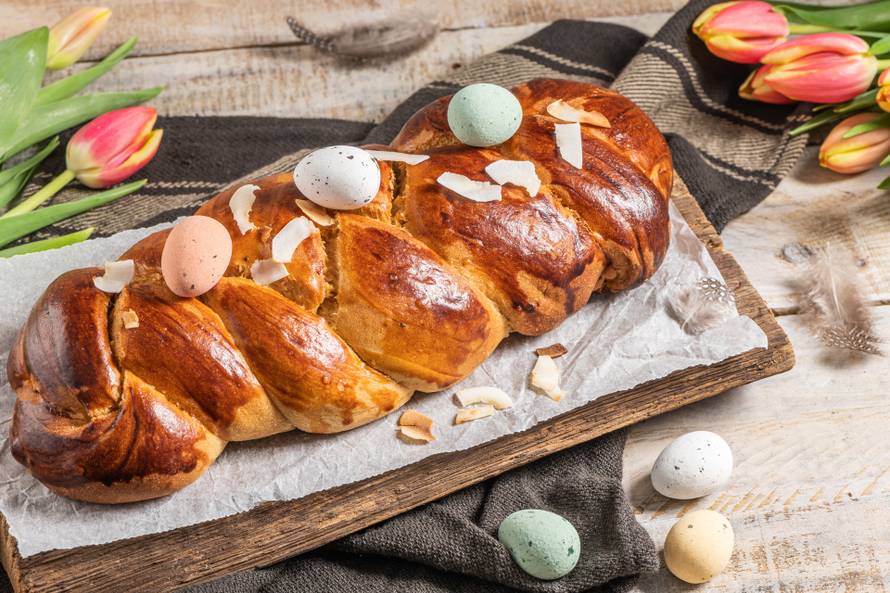Portuguese traditional Easter cake. Folar with eggs on easter ta