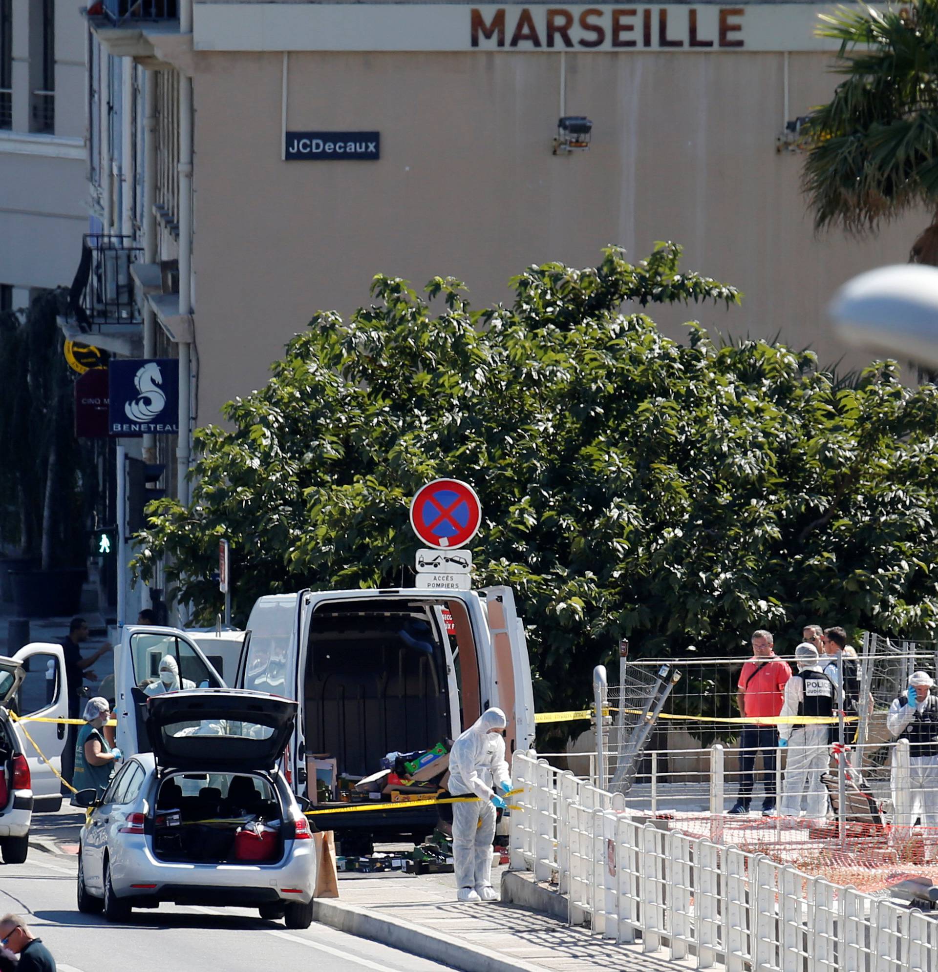 French police conduct their investigatation in the French port city of Marseille after one person was killed and another injured after a vehicle crashed into two bus shelters