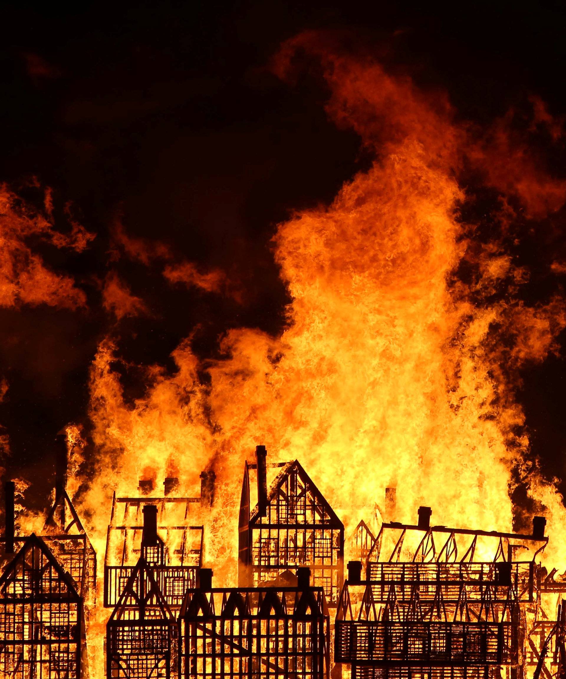 A 120-meter long model of the 17th century London skyline is set alight on the River Thames to commemorate the 1666 Great Fire of London in London