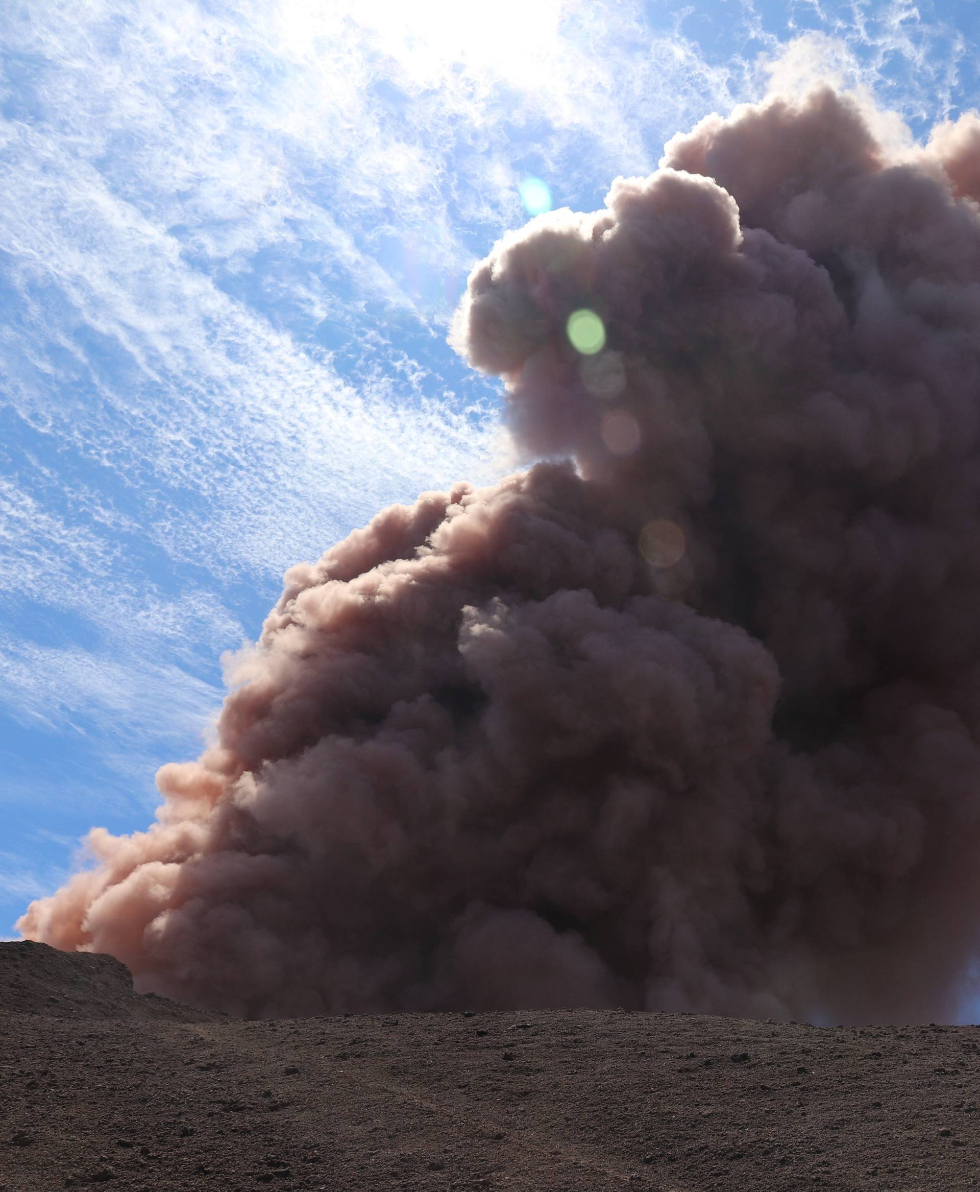 A plume of ash rises from Kilauea Volcano, one of five on the island, after a series of earthquakes over the last couple of days, in Hawaii