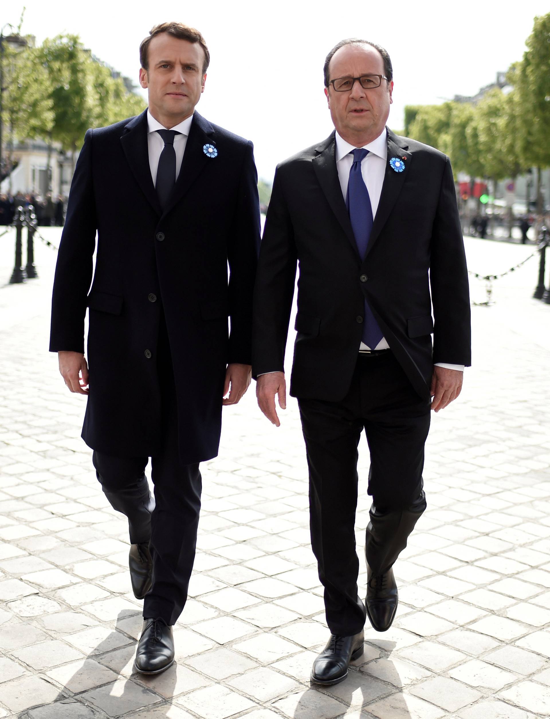 Outgoing French President Hollande and President-elect Macron attend a ceremony to mark the end of World War II at the Tomb of the Unknown Soldier at the Arc de Triomphe in Paris