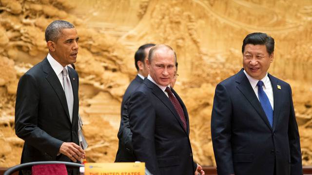 U.S. President Obama, arrives with Chinese and Russian counterparts, Xi and Putin, at the the APEC Summit plenary session in Beijing