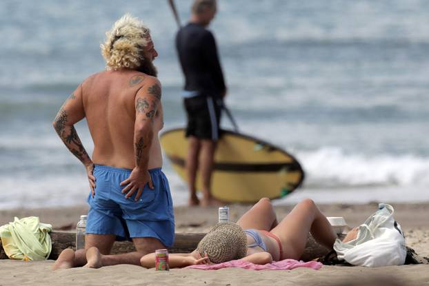 EXCLUSIVE: Shirtless Jonah Hill has his butt grabbed by his girlfriend Sarah Brady while doing yoga on the beach in Hawaii