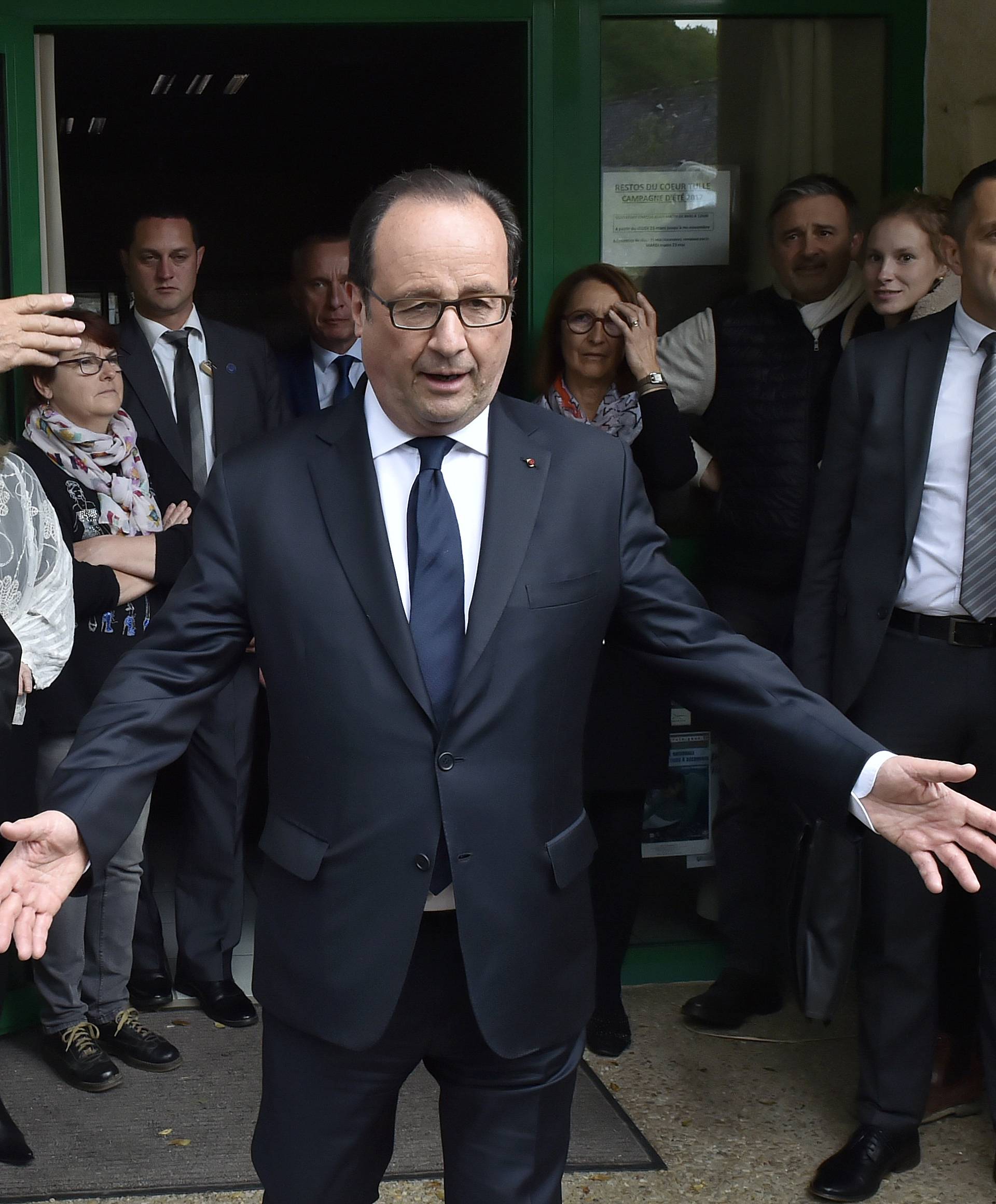French President Francois Hollande talks with residents  in the village of Saint Hilaire, near Tulle, during the second round of the 2017 French presidential election