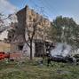 Emergency members work in the aftermath of a Russian military strike in the location given as Cherkasy