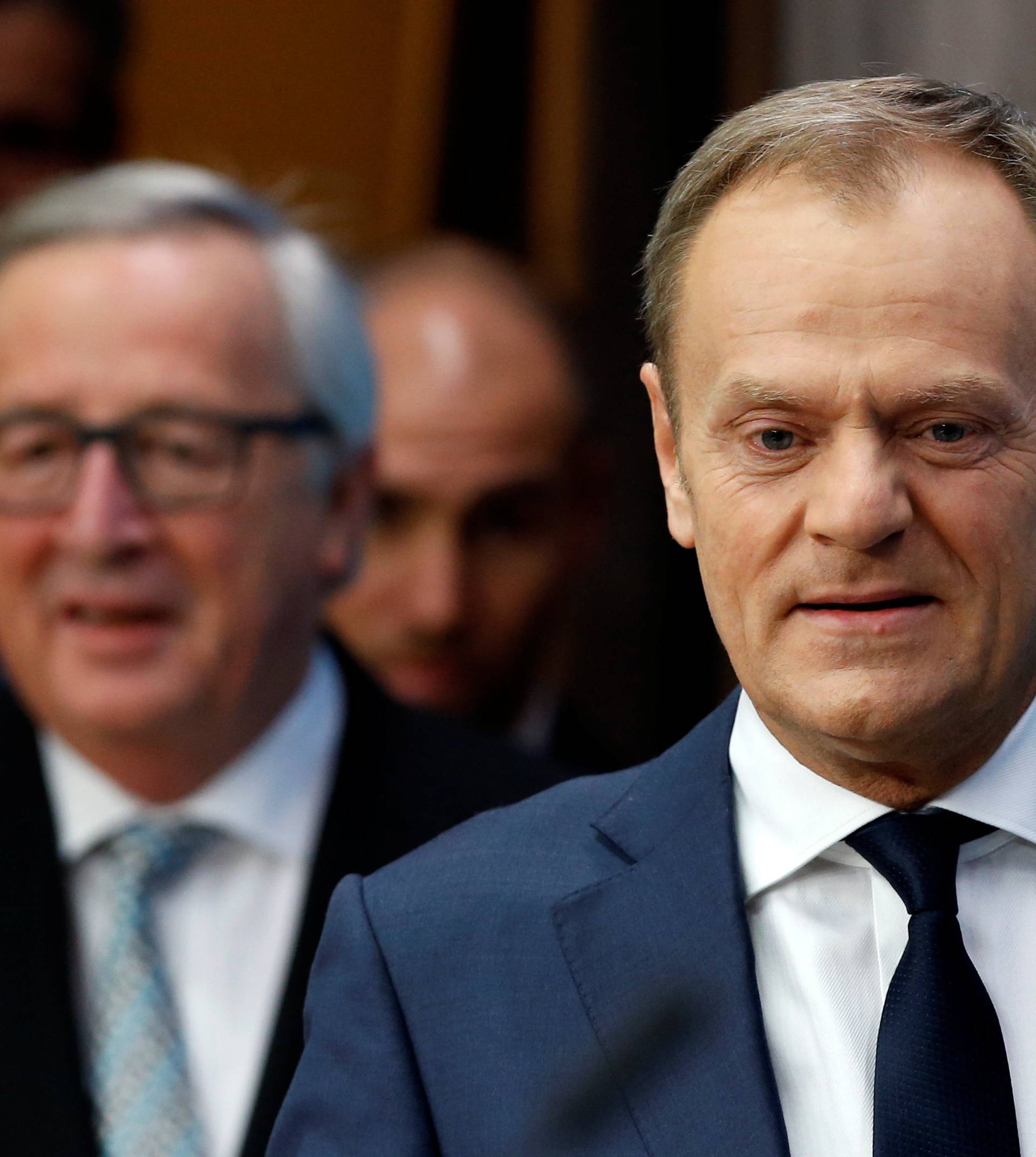 EU Council President Tusk and EU Commission President Juncker arrive to address a joint news conference during a EU leaders informal summit in Brussels