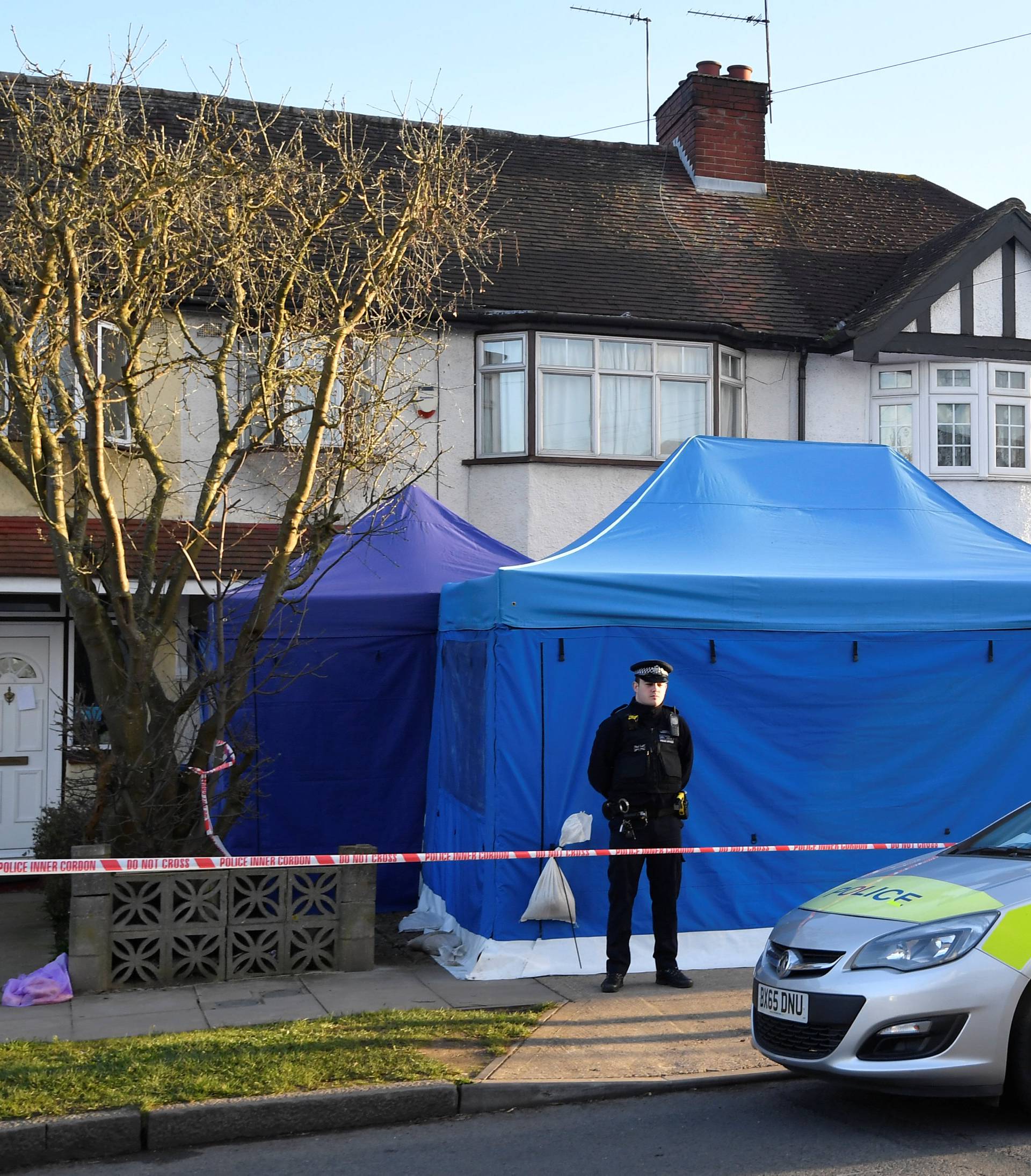 A police officer stands on duty outside the home of Nikolai Glushkov in New Malden, on the outskirts of London