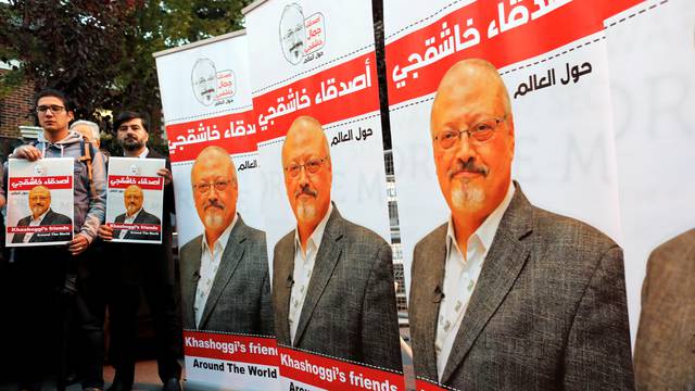 Friends of Saudi journalist Khashoggi hold posters and banners with his pictures during a demonstration outside the Saudi Arabia consulate in Istanbul