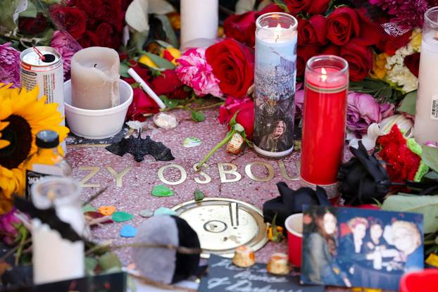 Flowers, candles and pictures are placed on the star of late Ozzy Osbourne at the Hollywood Walk of Fame in Los Angeles