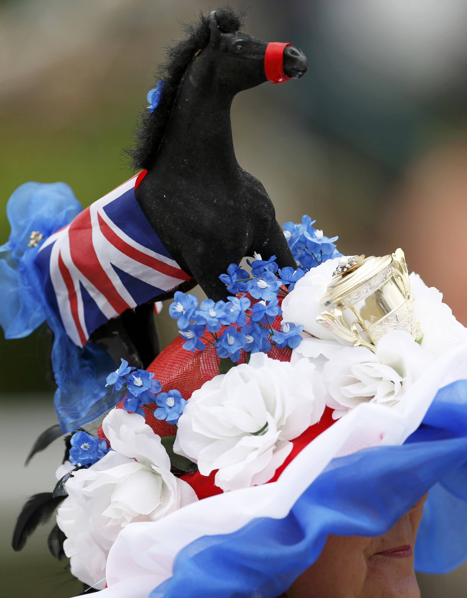 Britain Horse Racing Ladies Day Racegoer wears hat