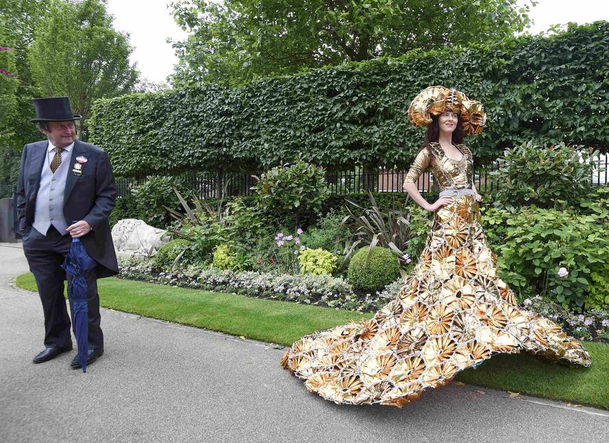 Britain Horse Racing Ladies Day Racegoer wears hat