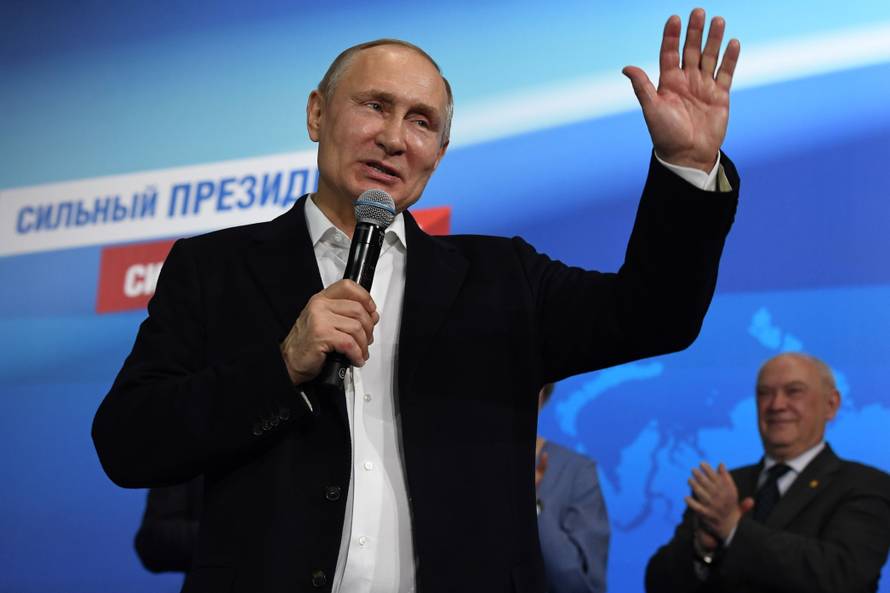 Russian President and Presidential candidate Putin speaks during a meeting with supporters at his campaign headquarters in Moscow