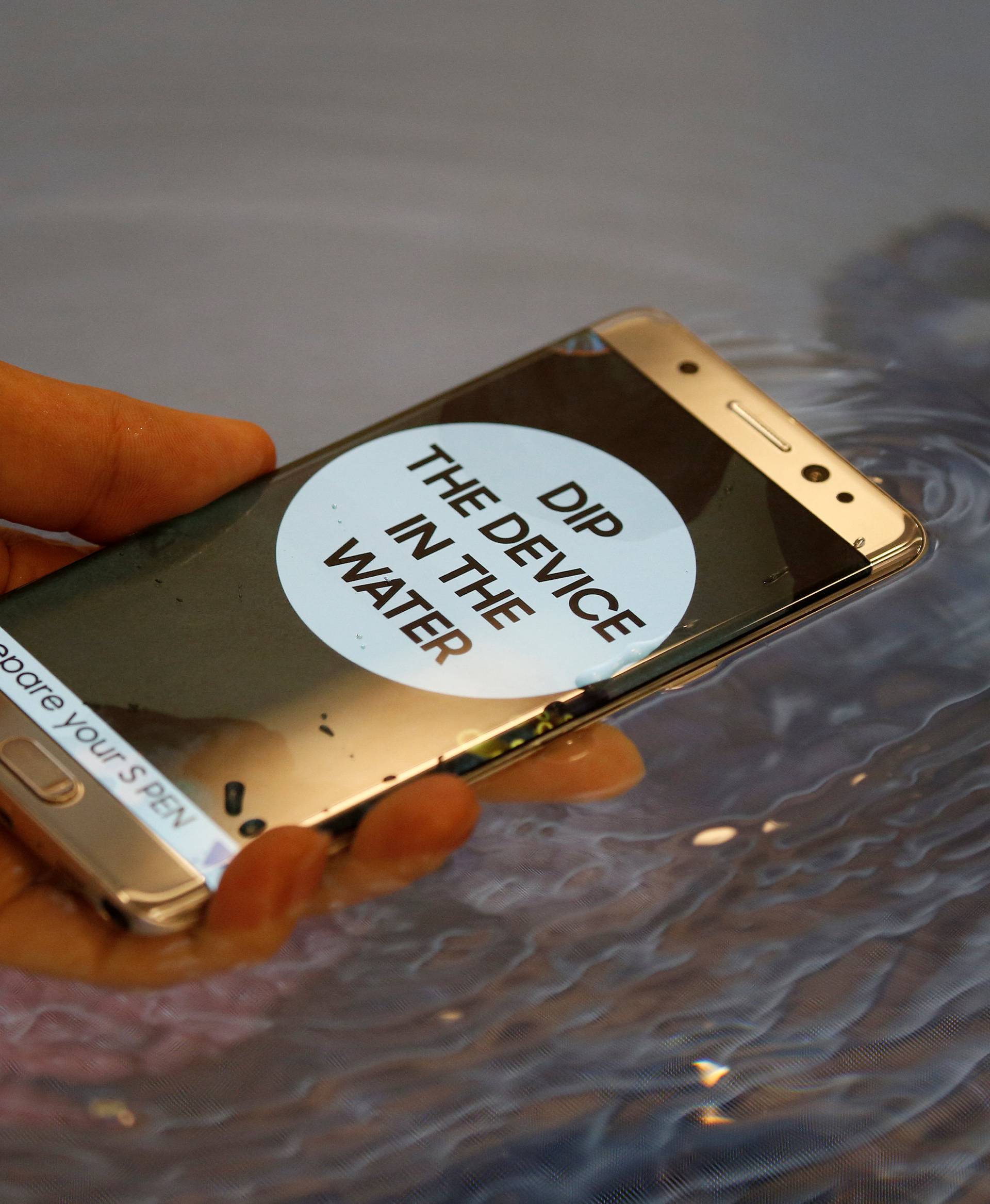 A model demonstrates waterproof function of Galaxy Note 7 new smartphone during its launching ceremony in Seoul