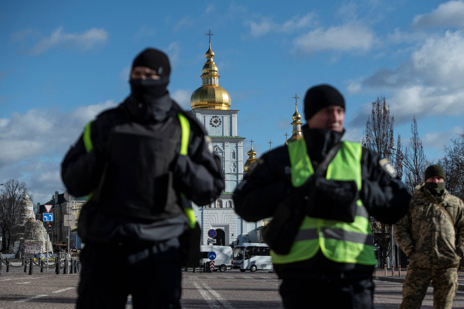 Police officers stand next to Mykhailivska Square in central Kyiv