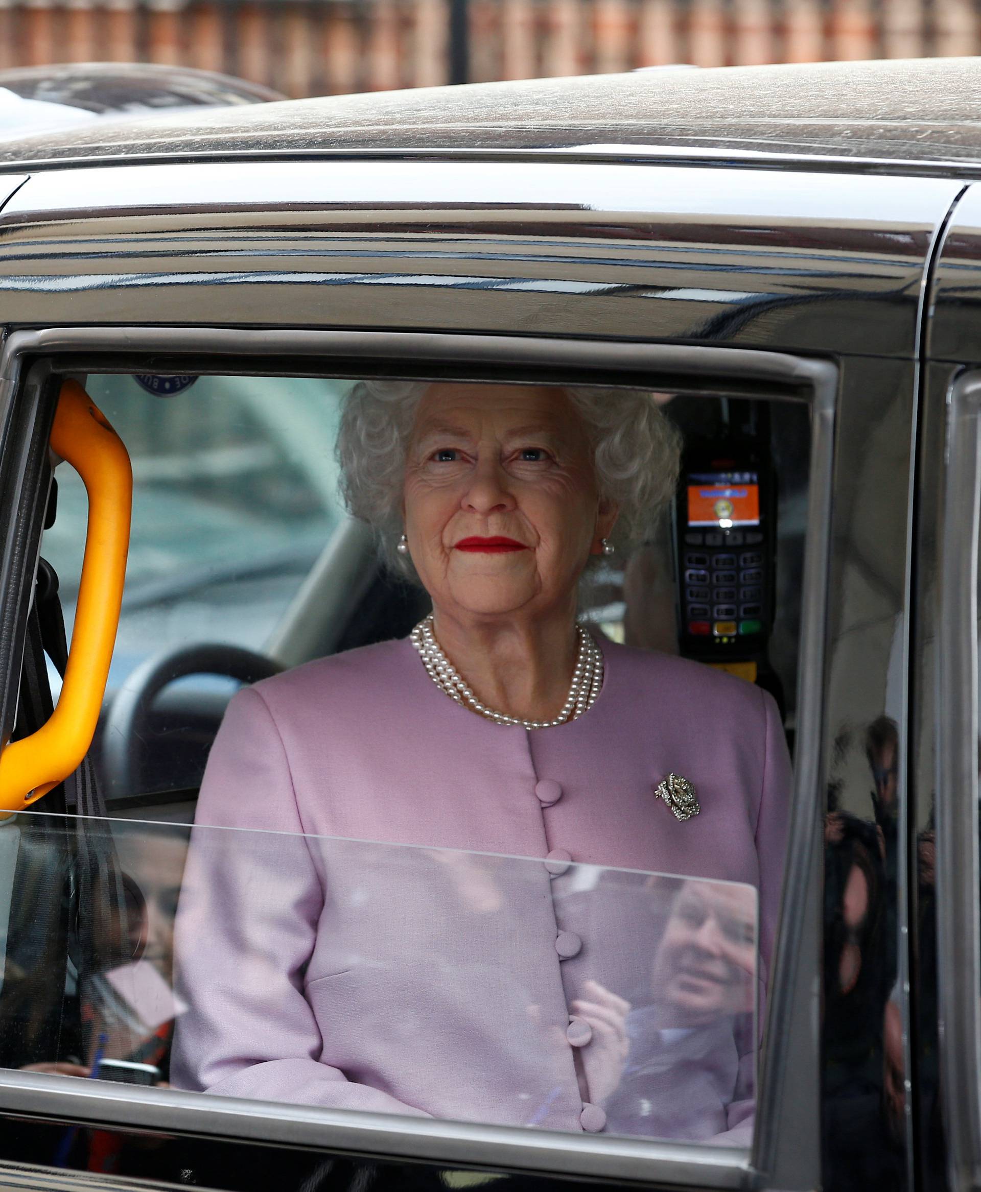 A person impersonating Britain's Queen Elizabeth is driven past the Lindo Wing of St Mary's Hospital after Britain's Catherine, the Duchess of Cambridge, gave birth to a son, in London