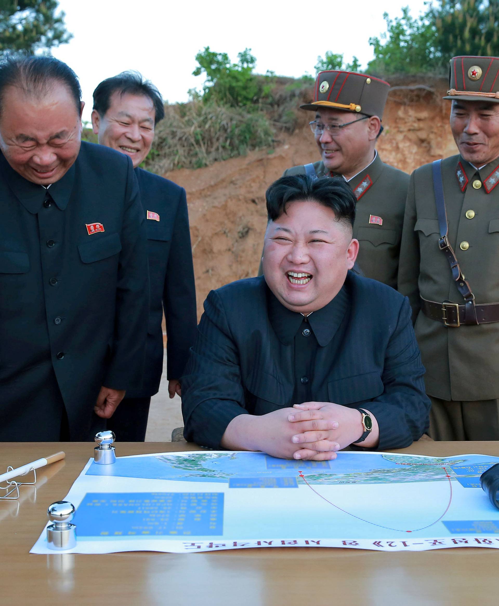 FILE PHOTO: North Korean leader Kim Jong Un reacts during the long-range strategic ballistic rocket Hwasong-12 (Mars-12) test launch