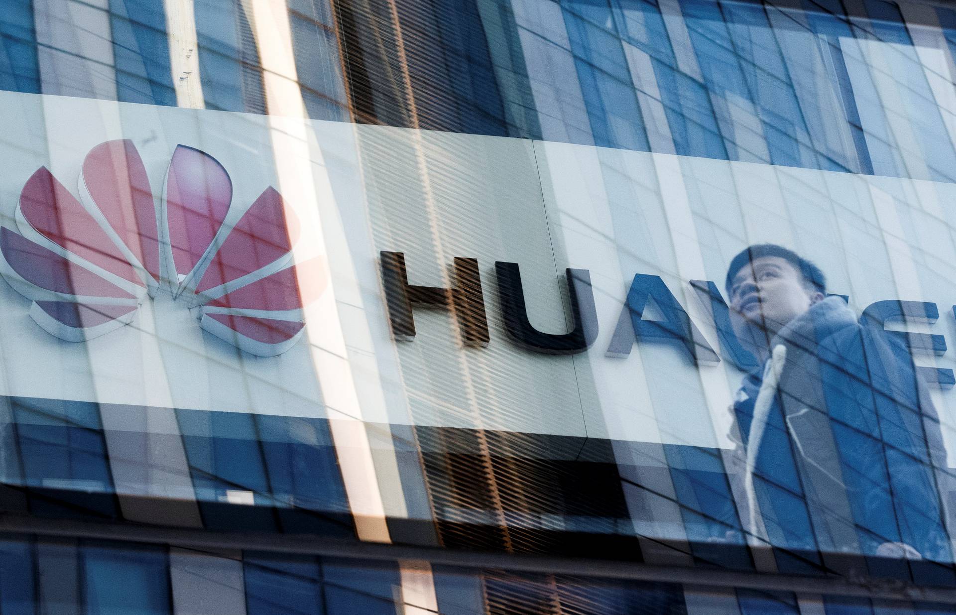 A man walks past a Huawei shop in Beijing