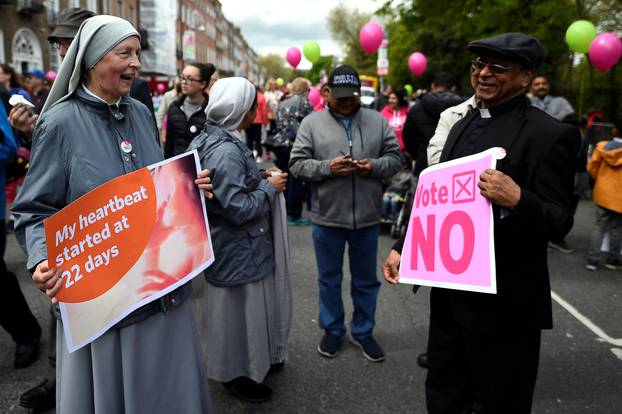 Sister Lucyna, a nun smiles with a priest as they take part in a 