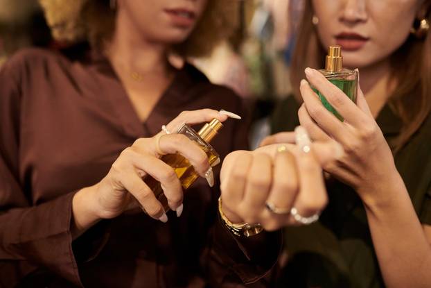 Close-up,Of,Woman,Putting,Perfume,On,Her,Wrist,And,Choosing