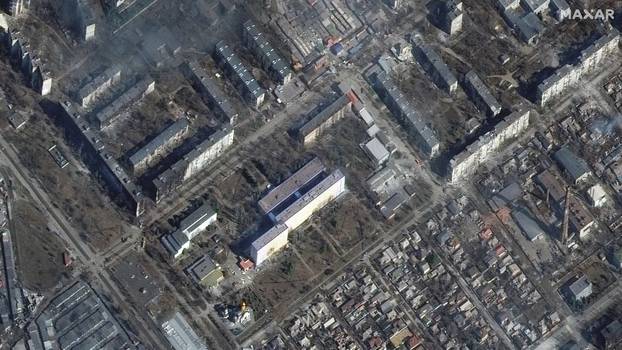 A satellite image shows a damaged hospital and apartment buildings in western Mariupol