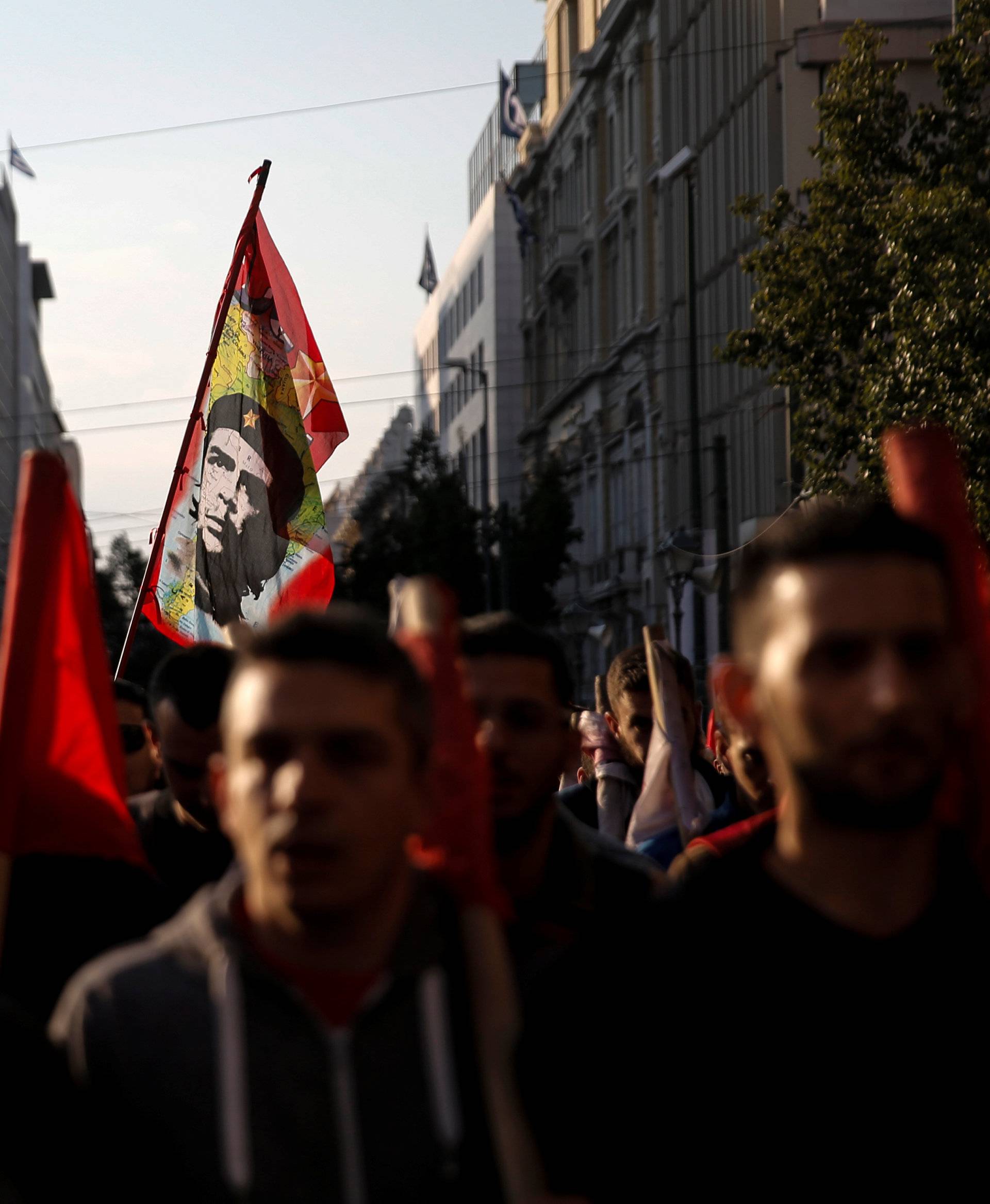 Members of the communist-affiliated PAME union march as a flag with an image of revolutionary leader Che Guevara waves during a 48-hour general strike against tax and pension reforms in Athens