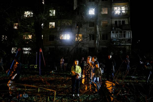 Firefighters work at the site of an apartment building hit by a Russian missile strike in Kyiv