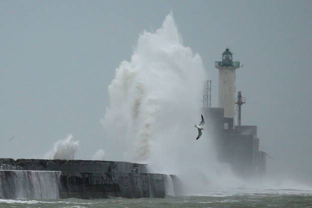 Waves crash against a lighthouse during Storm Ciara at Boulogne-sur-Mer