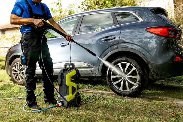 Outdoor,Scene,Of,Man,In,Protective,Clothing,Washing,Car,In