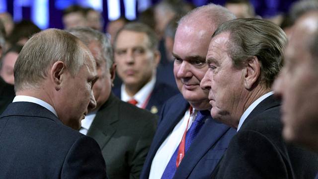 FILE PHOTO: FILE PHOTO: Russian President Putin and former German Chancellor Schroeder, chairman of the shareholders’ committee at Nord Stream AG, attend the Energy Week International Forum in Moscow