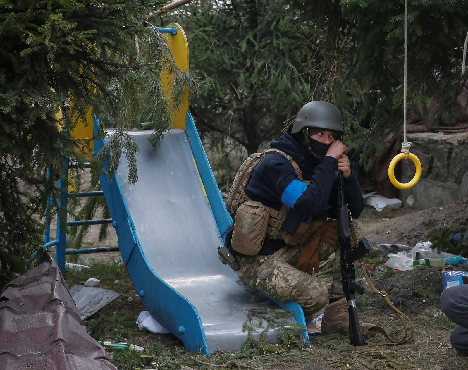 A Ukrainian service member rests on the front line near Kyiv