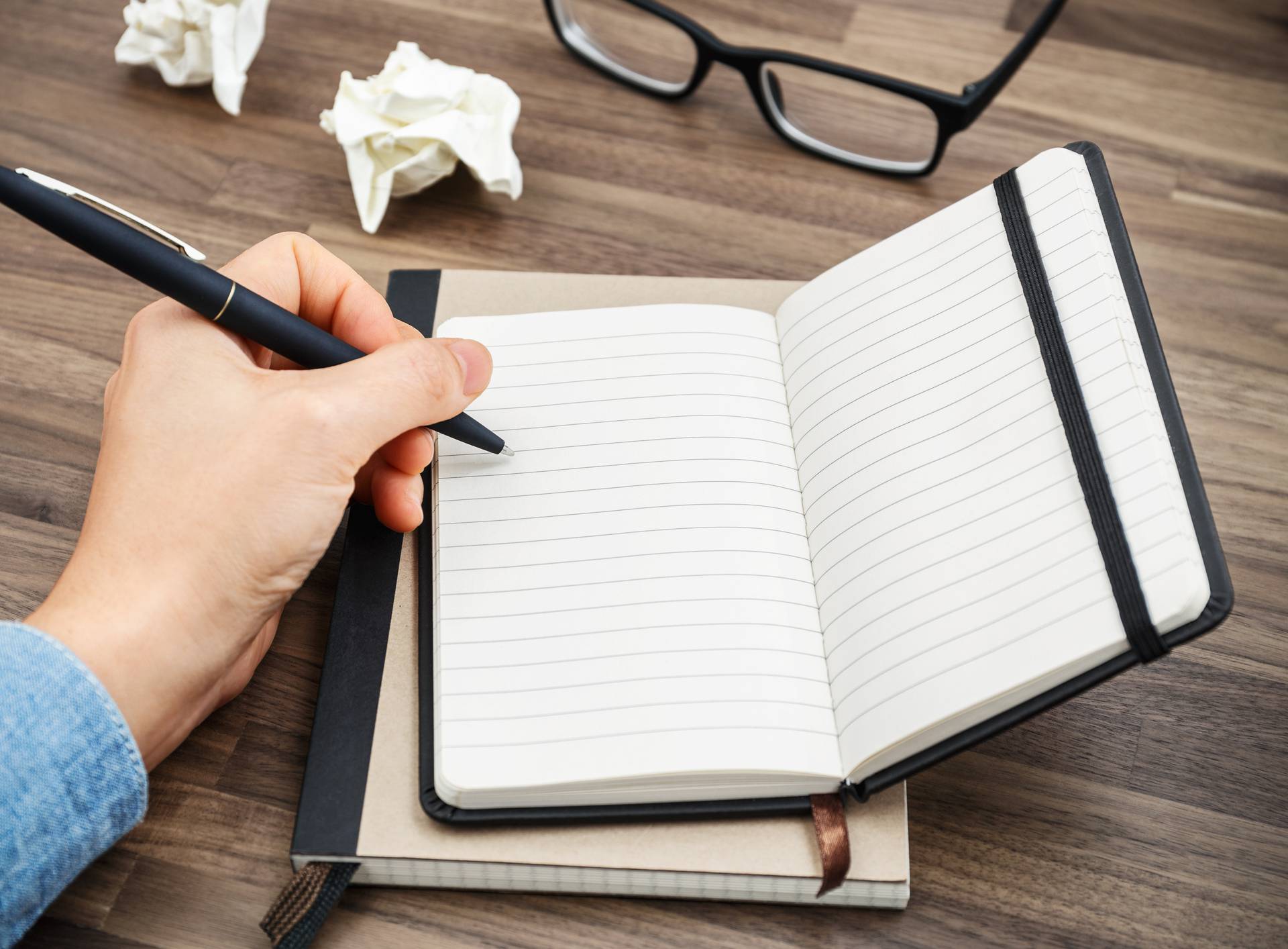 Woman hand writing on notebook